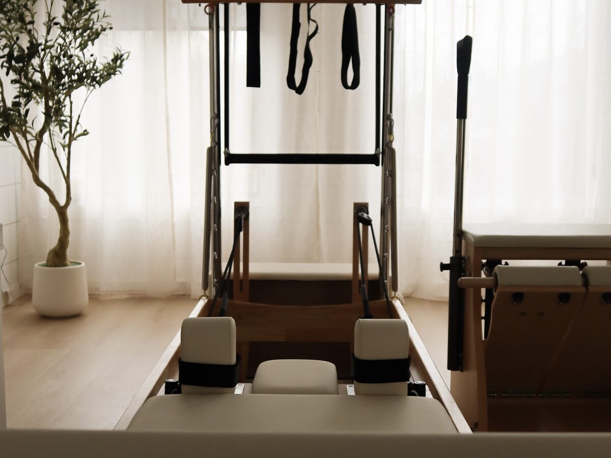 A reformer and tower in the ALYN studio, beside an olive tree in soft window light